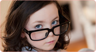 A child wearing an adult's glasses